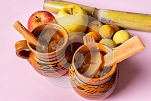 Mexican christmas punch with fruits on pink background