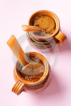 Mexican christmas punch with fruits on pink background