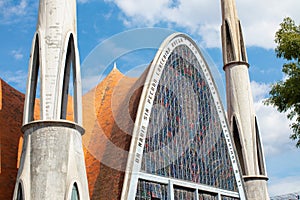 mexican church with a big stained glass facade colorful front, Our Lady of the Miraculous Medal Parish exterior