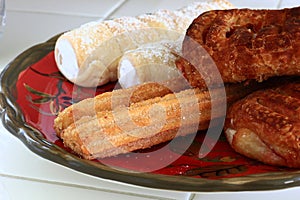 Mexican Churros with cream horns and danishes photo