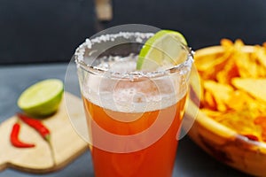 Mexican cocktail, michelada, made with beer and tomato juice. Selective focus