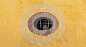 Mexican colonial oval peculiar window with yellow wall