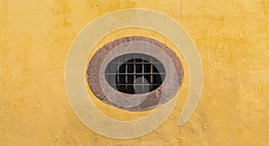 Mexican colonial oval peculiar window with yellow wall photo