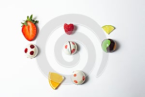 Mexican Colorful chocolate candy bonbons with fruits orange, lemon n and strawberries on white background in Mexico city