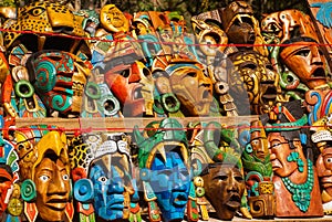 Mexican crafts for tourists on the market. Colorful Souvenirs, masks of Mayan warriors. Mexico