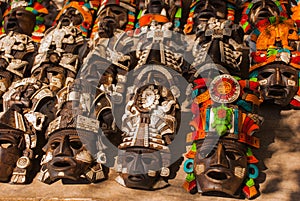 Mexican crafts for tourists on the market. Colorful Souvenirs, masks of Mayan warriors. Mexico