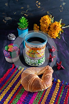 Mexican Cuernito Bread, Sugar Croissant and Coffee Jar on Woven Tablecloth. photo