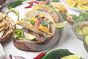 Mexican cuisine - mexican tacos al pastor, pork meat, corn tortillas, chili pepper, pineapple, avocado, cilantro, lime