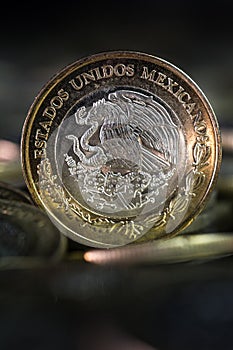 Mexican currency in the foreground,With dark background