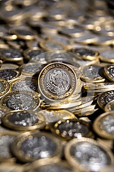 Mexican currency With many more coins in the background, Vertical