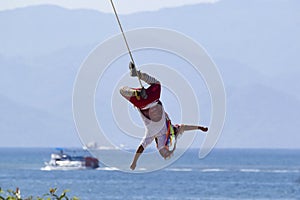 Volador is flying on the rope in ancient ritual dance in Mexico photo