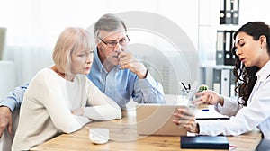 Mexican doctor explaining diagnosis to elderly couple