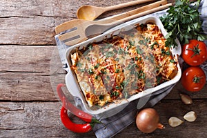 Mexican enchilada in a baking dish horizontal top view