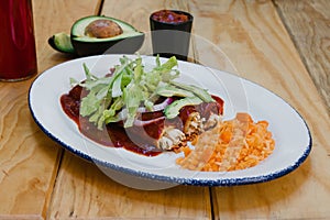Mexican enchiladas rojas with chicken lettuce and onions Food in Mexico photo