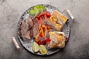 Mexican fajita sandwiches on stone table from above