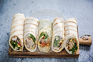 Mexican fajita wraps on serving board, copy space