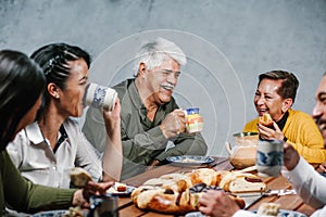 Mexican family eating Rosca de Reyes or Epiphany cake, Roscon de reyes with traditional mexican chocolate cup in Mexico