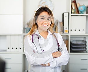 Mexican female medic in uniform standing in doctor's office