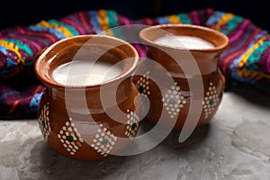 Mexican fermented beverage called pulque on a gray background