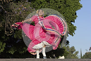 A Mexican folk dancer wearing traditional costume photo