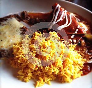 Mexican food. Enchilada, rice and beans.