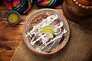 Mexican food enfrijoladas table top view