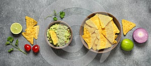 Mexican food guacamole with nachos, gray concrete background, banner. View from above