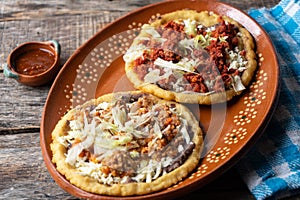 Mexican food: sopes of Chorizo and beef picadillo with cheese and beans
