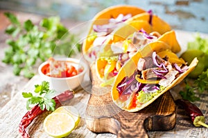 Mexican food tacos, fried chicken, greens, mango, avocado, pepper, salsa