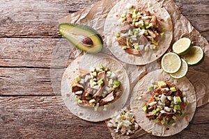 Mexican food: tortilla with carnitas, onions and avocado. horizontal top view