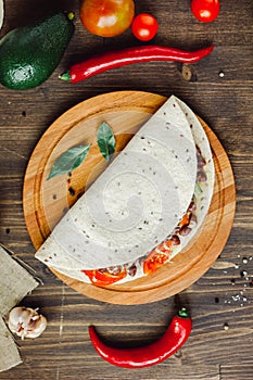 Mexican food - vegetarian quesadilla on wooden board.