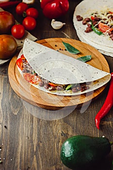 Mexican food - vegetarian quesadilla on wooden board.