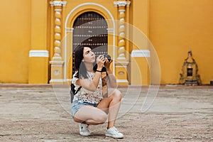Mexican girl with camara, Female photographer taking pictures on South America in vacations photo
