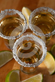 Mexican Gold Tequila with lime slices and salt, top view