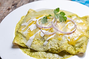 Mexican green enchiladas with melted cheese also called Suizas photo