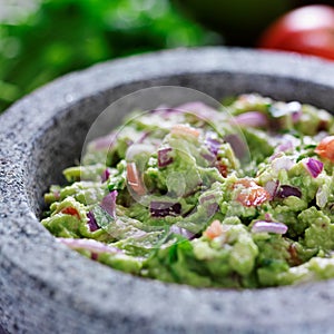 Mexican guacamole in stone molcajete