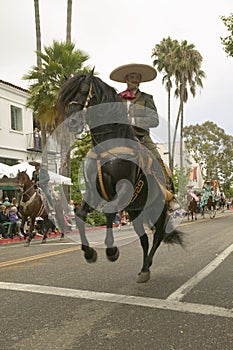 Mexican horseback riders trot along during the opening day parade down State Street of Old Spanish Days Fiesta held every August