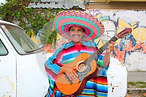 Mexican humor man smiling playing guitar sombrero