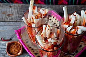 Mexican jicama fruit cutted with lime, chili powder and chamoy