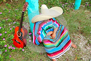 Mexican lazy sombrero hat man poncho nap garden photo