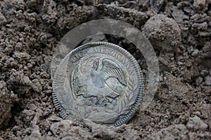 1843 Mexican Libertad Silver Coin on Ground in Dirt Back View photo