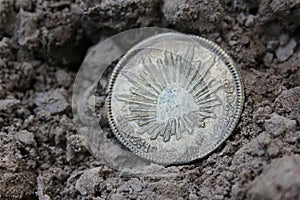 1843 Mexican Libertad Silver Coin on Ground in Dirt Front View