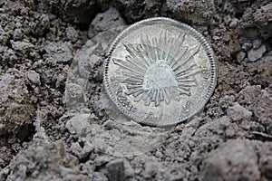 1843 Mexican Libertad Silver Coin on Ground in Dirt Front View photo