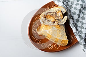 Mexican mole tamal sandwich also called Guajolota