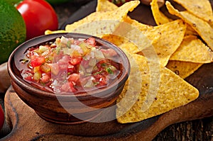 Mexican nacho chips and salsa dip photo