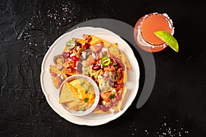 Mexican nachos with chili con carne and a Paloma cocktail