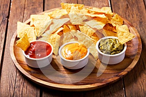 Mexican nachos corn chips with guacamole, salsa and cheese dip