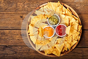 Mexican nachos corn chips with guacamole, salsa and cheese dip