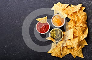 Mexican nachos corn chips with guacamole, salsa and cheese dip photo
