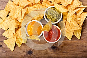 Mexican nachos corn chips with guacamole, salsa and cheese dip photo